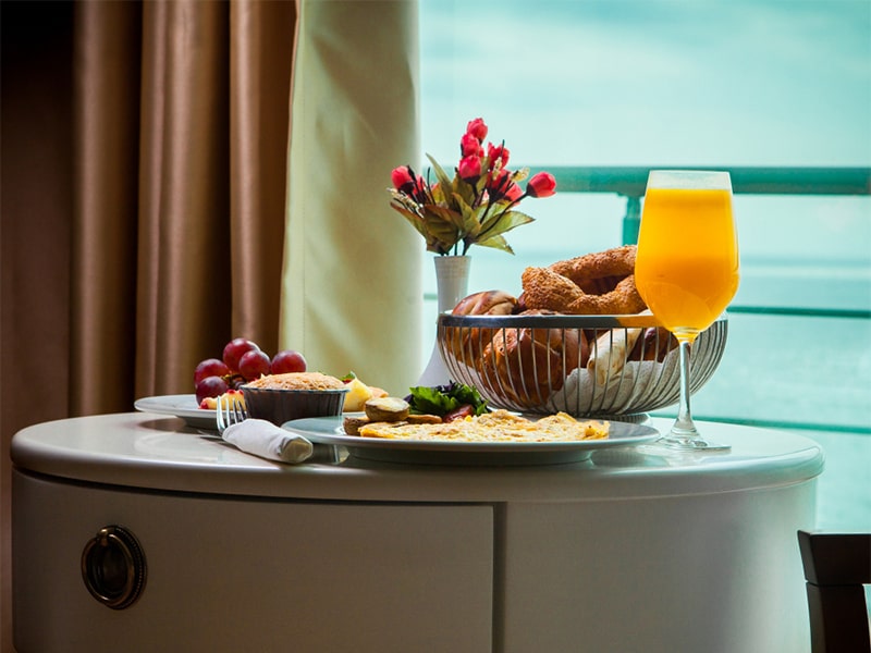 side-view-breakfast-omelet-with-mushrooms-juice-croissants-room-service-hotel-with-amazing-sea-view